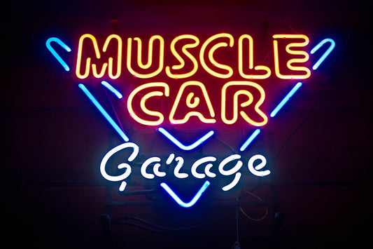 Neon sign reading Muscle Car Garage with vibrant red, yellow, and blue lights