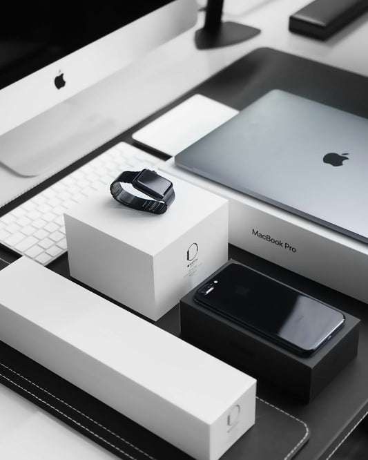 Apple MacBook Pro, iPhone, Apple Watch and accessories on modern office desk