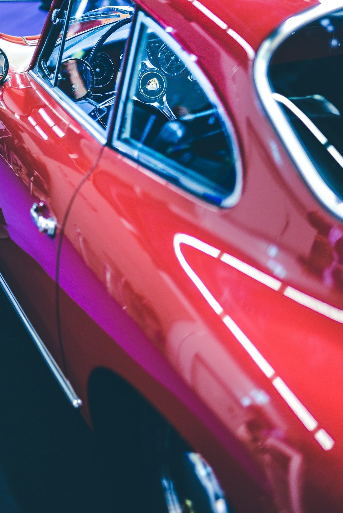 Close-up of a red exotic sports car exterior and classic dashboard