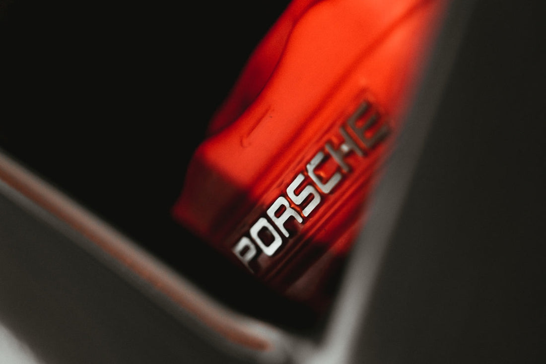 Close-up of red Porsche engine cover with logo, luxury supercar detail