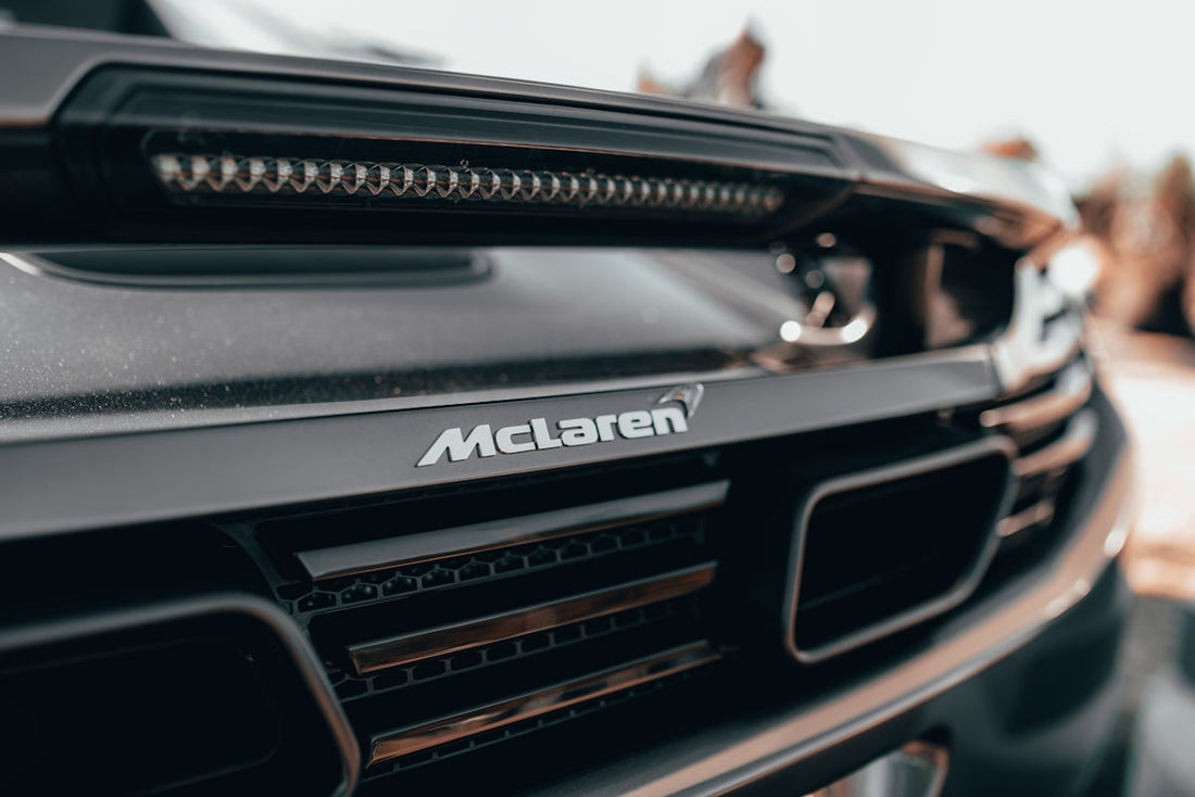 Close-up of McLaren supercar rear badge and grille, luxury exotic car detail