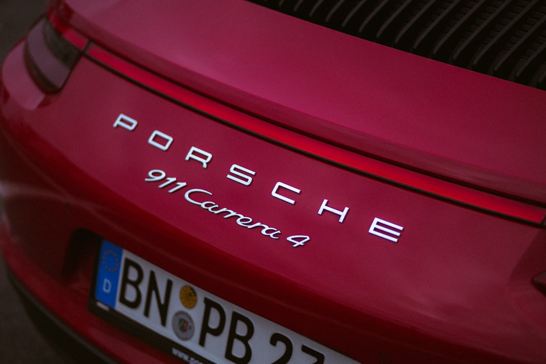 Close-up of red Porsche 911 Carrera 4 rear badge and European license plate