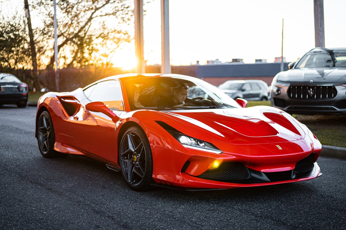 Red Ferrari supercar parked on street at sunset, exotic car exterior close-up