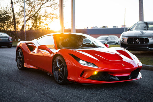 Red Ferrari supercar parked on street at sunset, exotic car exterior close-up