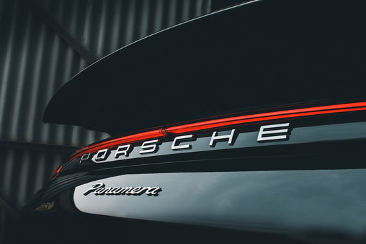 Close-up of Porsche Panamera rear badge and taillight on a luxury sports car