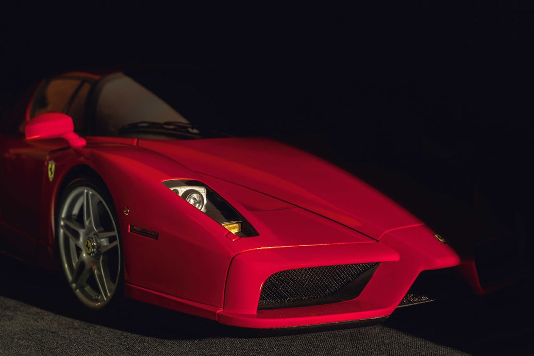 Close-up of red Ferrari exotic supercar front, silver alloy wheel and headlight detail