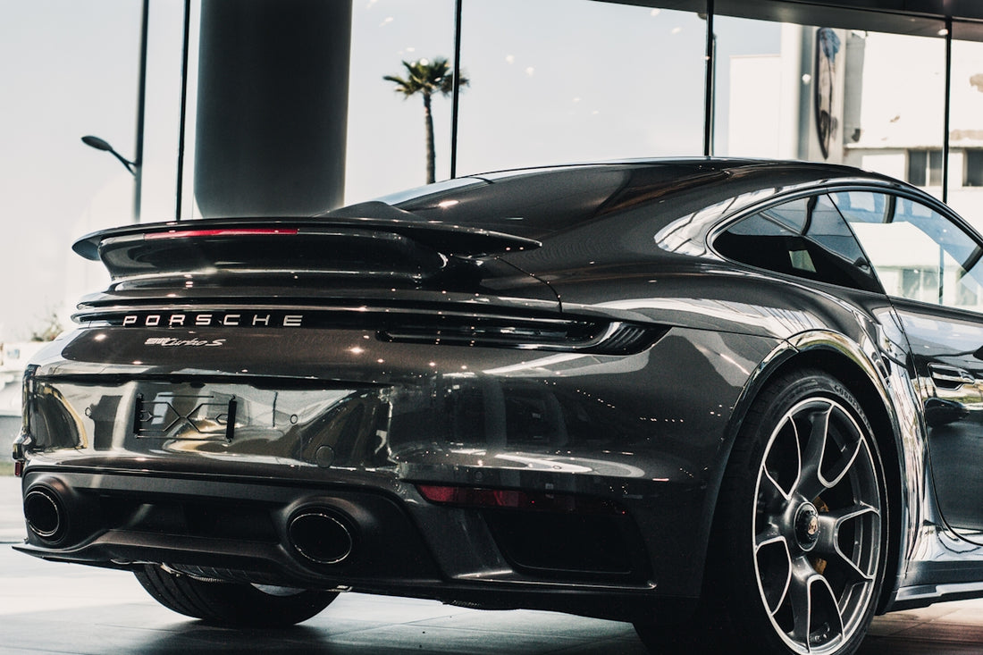 black porsche 911 parked in a parking lot