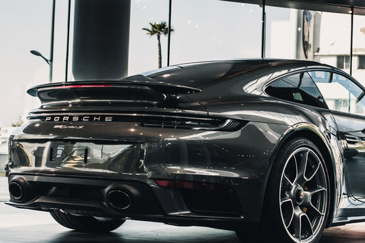 black porsche 911 parked in a parking lot