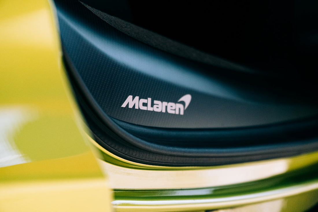 Close-up of McLaren car door sill with logo, luxury sports car detail