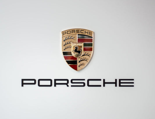 Porsche crest and logo on a plain light background, luxury car emblem