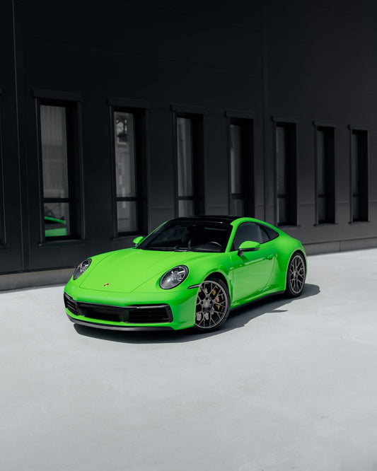 Bright green luxury sports car parked outside modern building, exotic car accessories