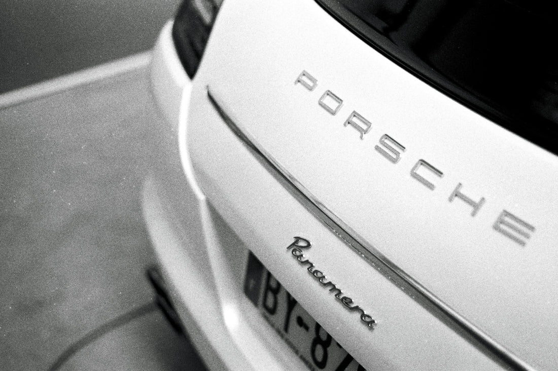 Close-up of rear Porsche Panamera badge on a luxury car in monochrome style