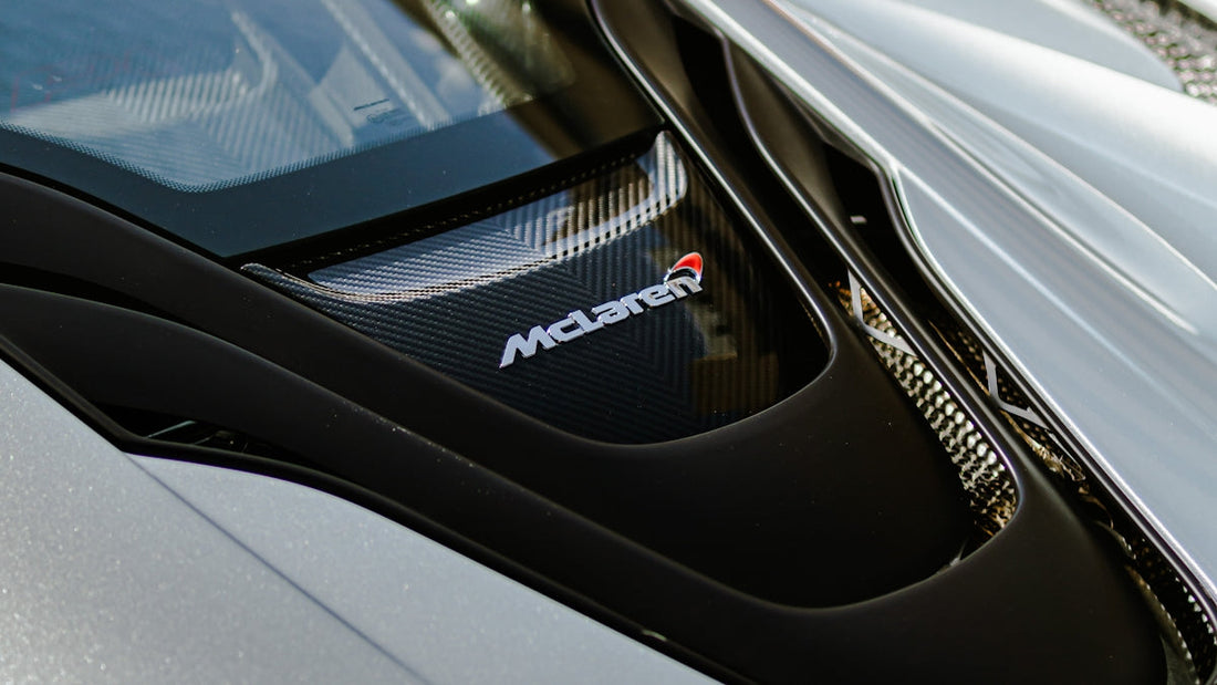 Close-up of McLaren engine cover with carbon fiber detail on a luxury sports car
