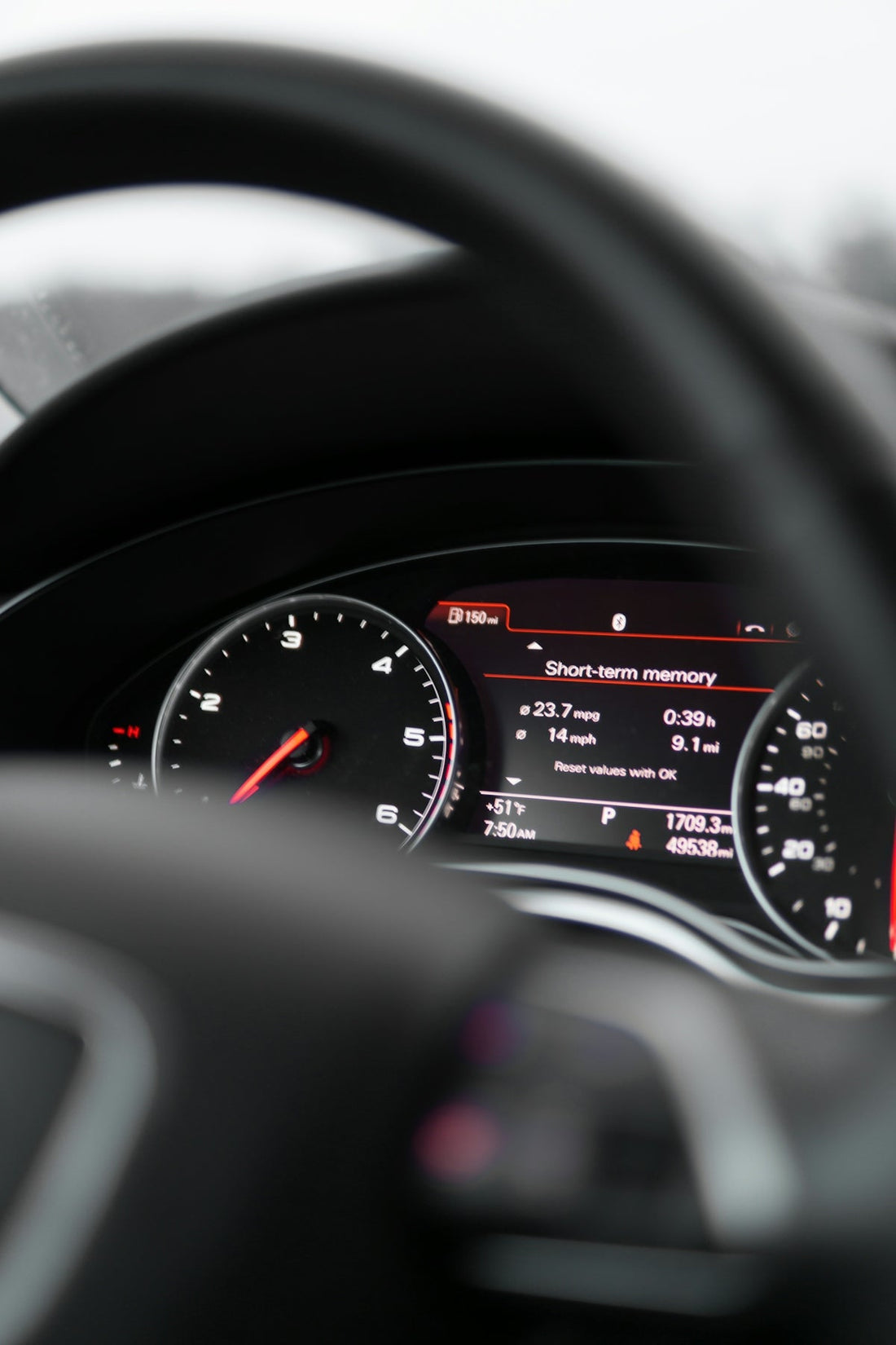 Close-up of a luxury car digital dashboard display with speedometer and performance stats