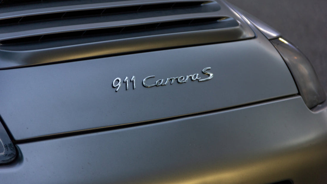 Close-up of Porsche 911 Carrera S rear badge and engine cover in silver