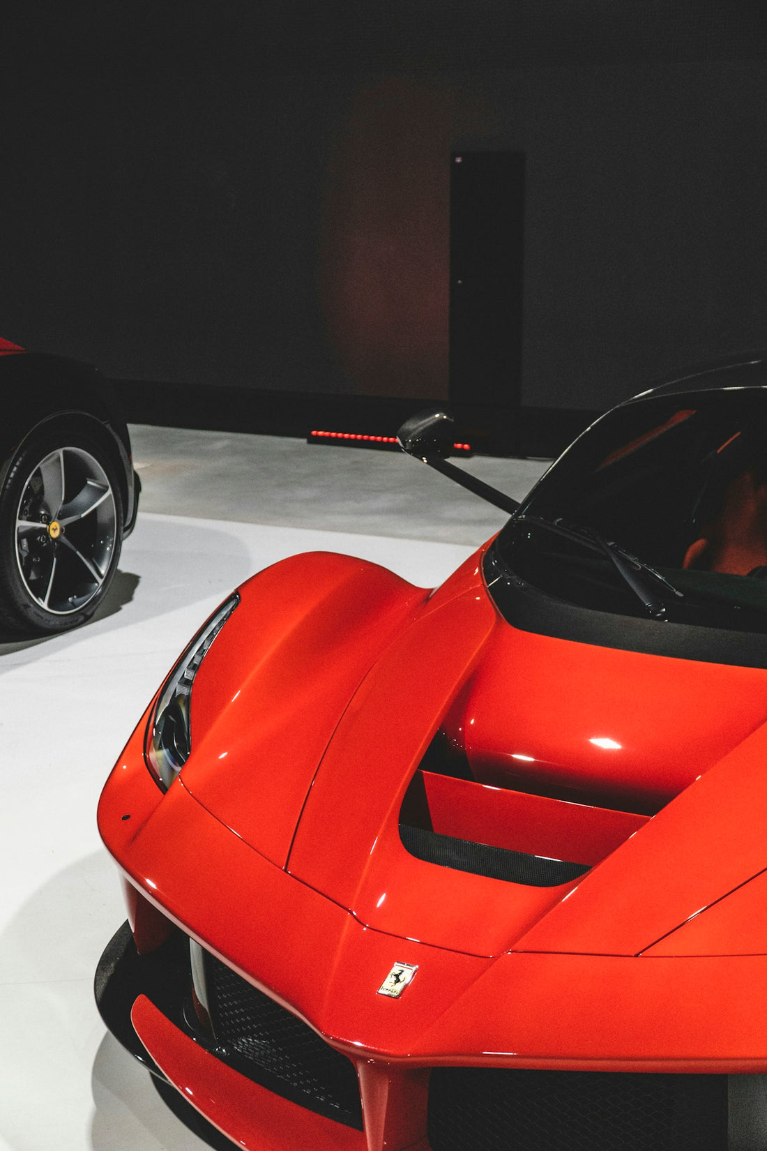 a red sports car is on display at a car show