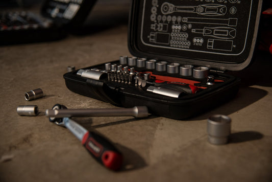 Automotive socket wrench set with ratchet and sockets on a garage floor