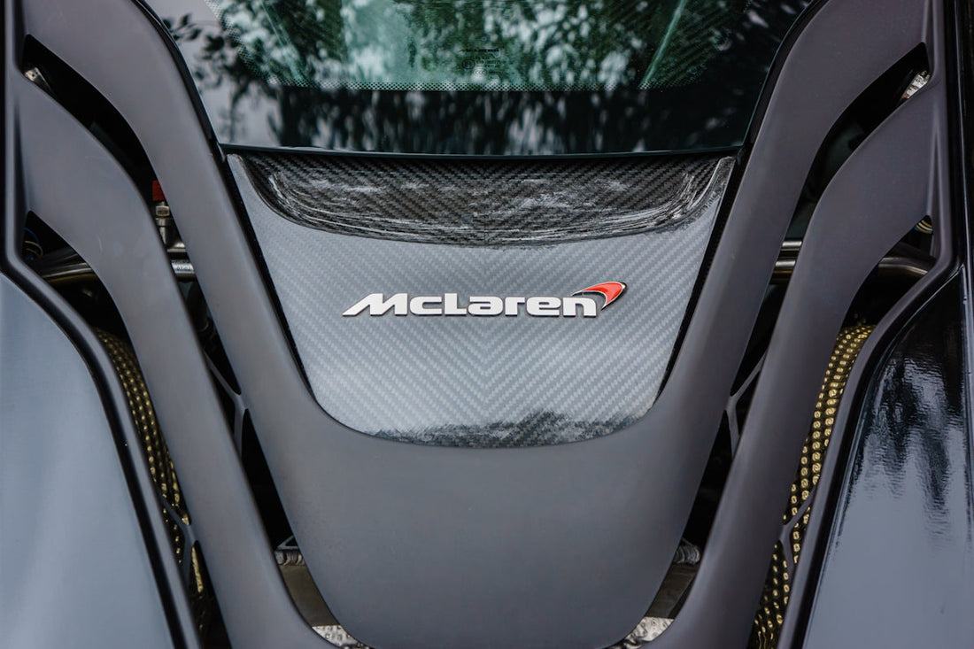 Close-up of McLaren supercar engine cover with carbon fiber detailing