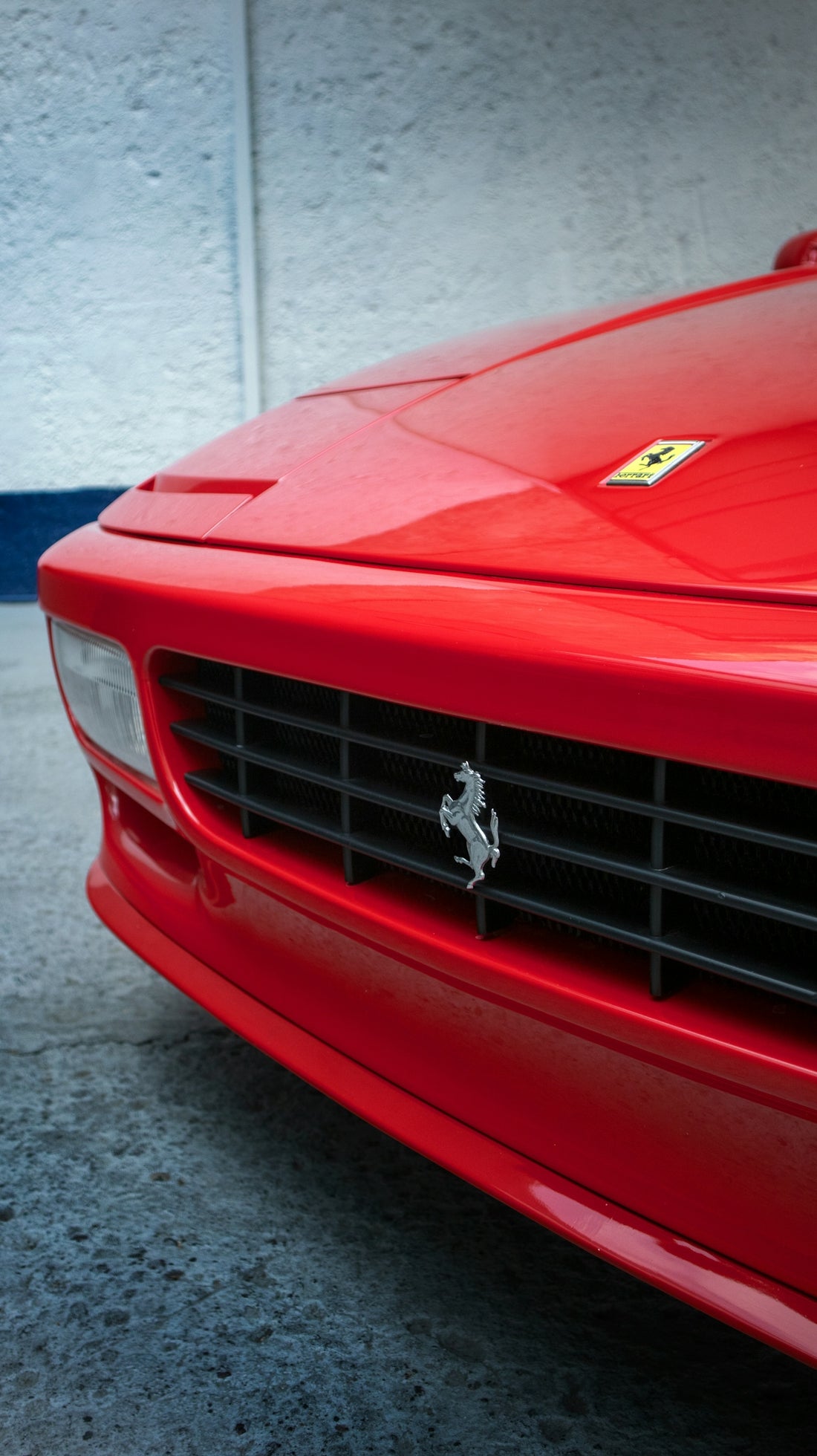 a red ferrari sports car parked in a garage