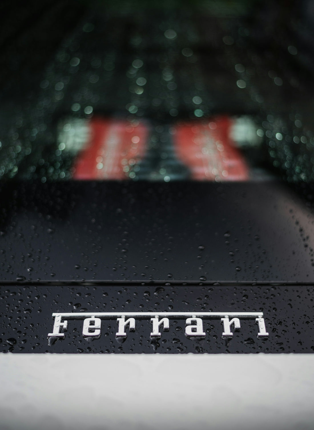 the rear end of a car with the word ferrari on it