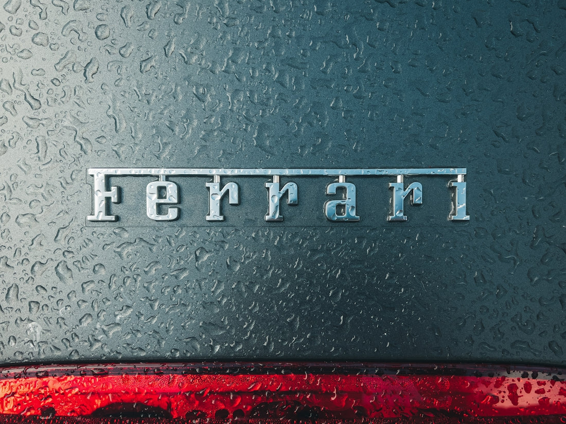 a close up of the word ferrari on the side of a car