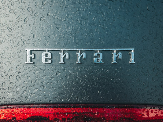 a close up of the word ferrari on the side of a car