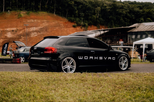 a black car parked on the side of a road