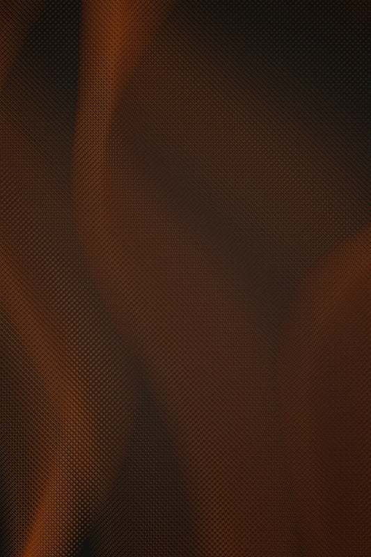 close-up of textured carbon fiber surface with orange-brown lighting