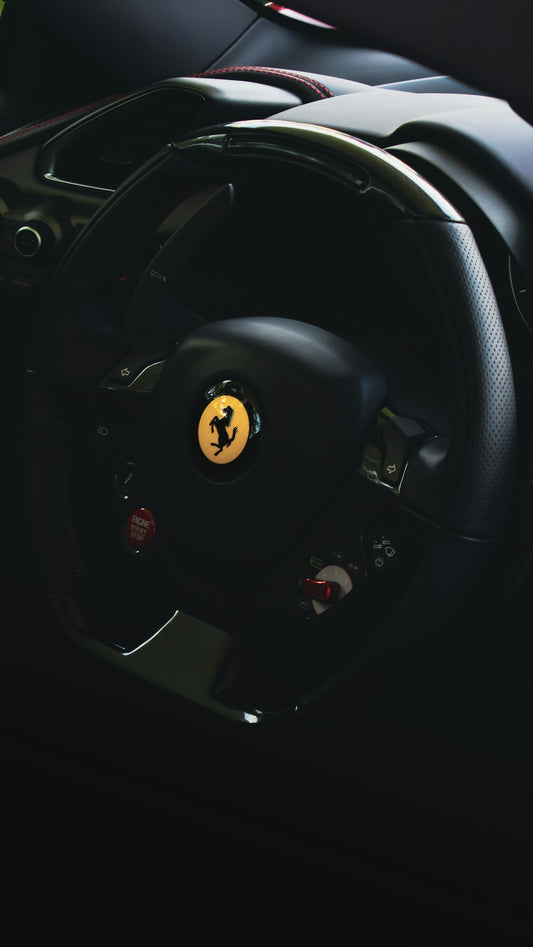 the steering wheel of a ferrari sports car