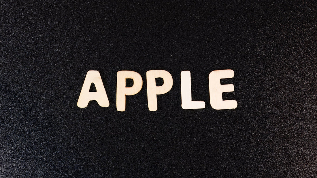 Wooden letters spelling APPLE on a black textured background, Apple CarPlay concept