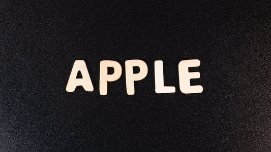 Wooden letters spelling APPLE on a black textured background, Apple CarPlay concept