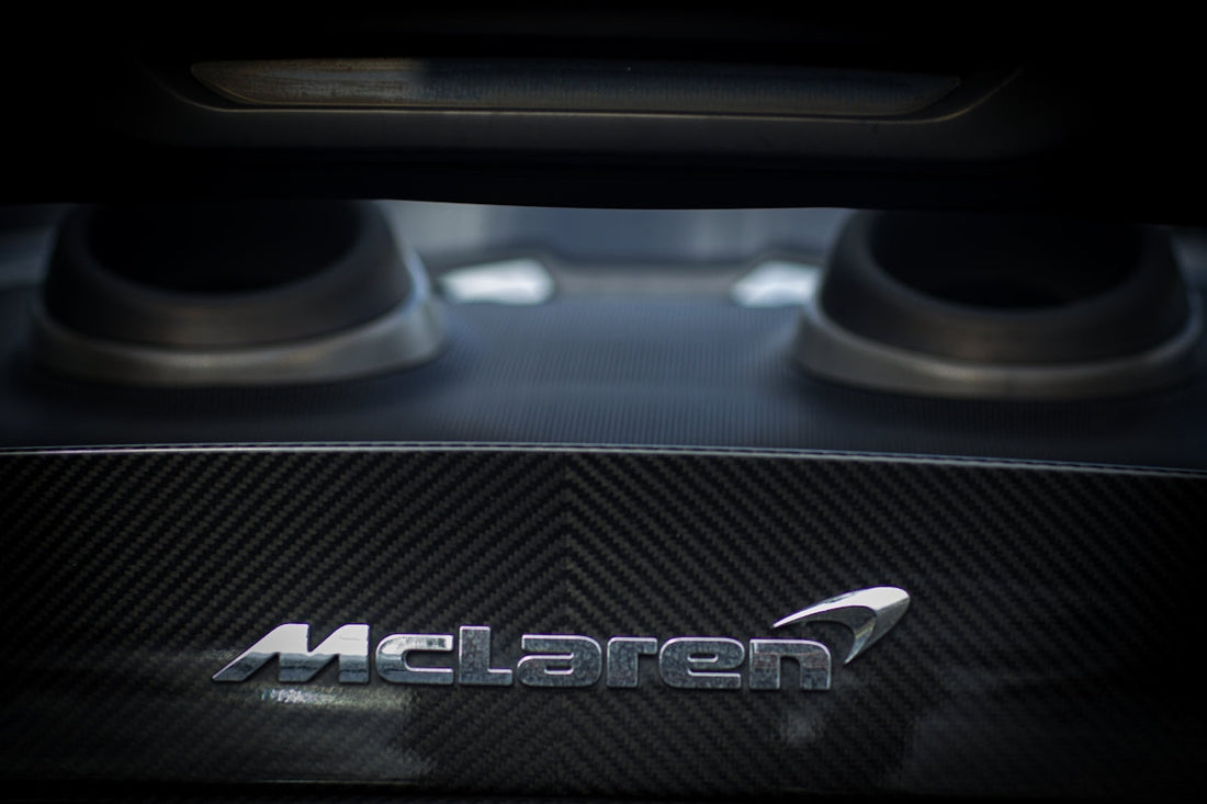 Close-up of McLaren carbon fiber engine cover with dual exhaust outlets