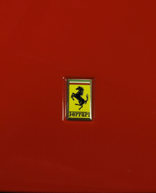 a ferrari emblem is shown on a red car