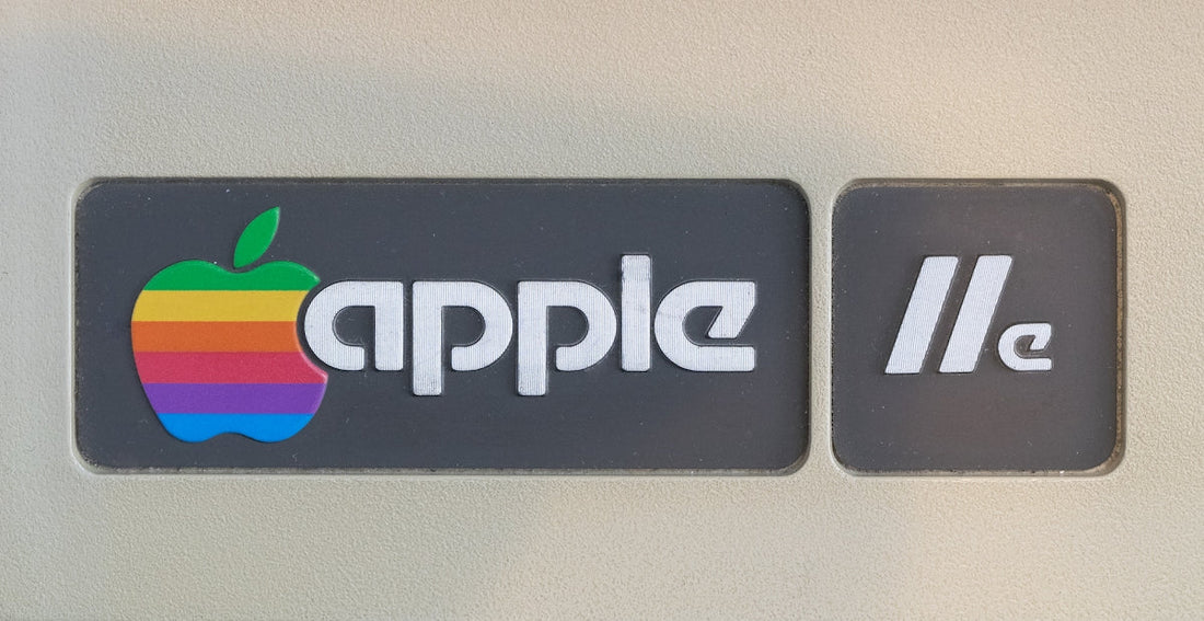 Close-up of Apple IIe vintage computer logo with rainbow apple and beige casing