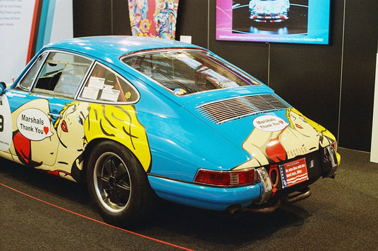 Classic blue sports car with pop art graphics and 'Marshals Thank You' text on display.