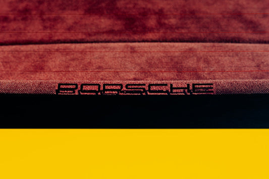 Close-up of Porsche rear window with red suede interior and yellow exterior trim