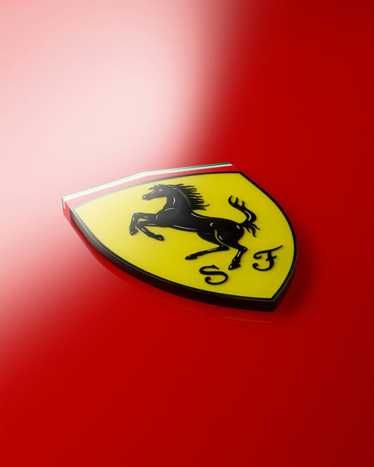 A close up of a ferrari badge on a red car