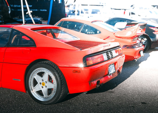 A red sports car parked in a parking lot