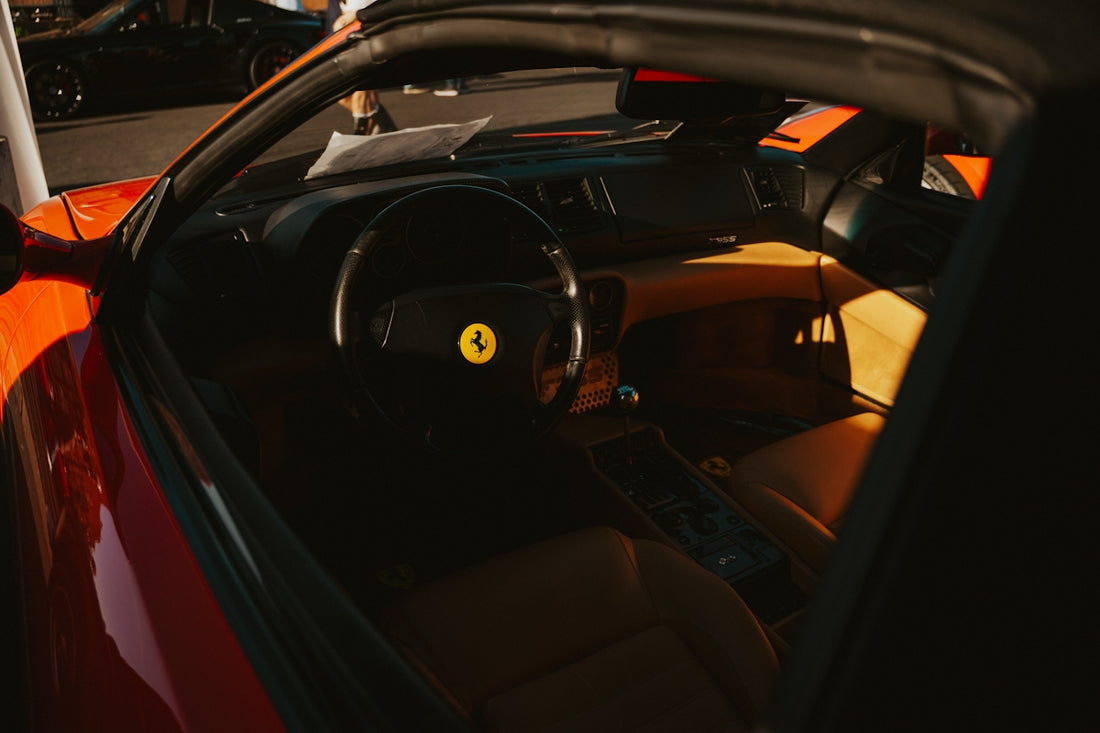 Interior view of a red ferrari sports car.