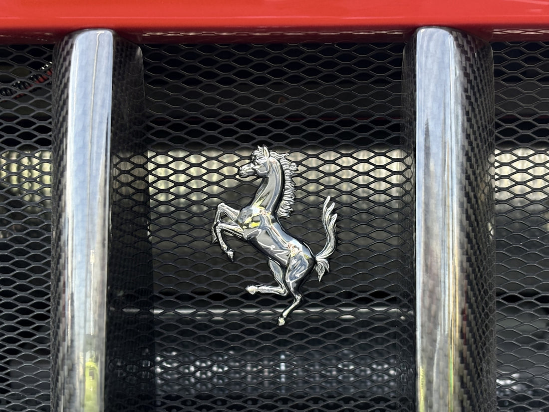 A ferrari emblem on its car's grill.