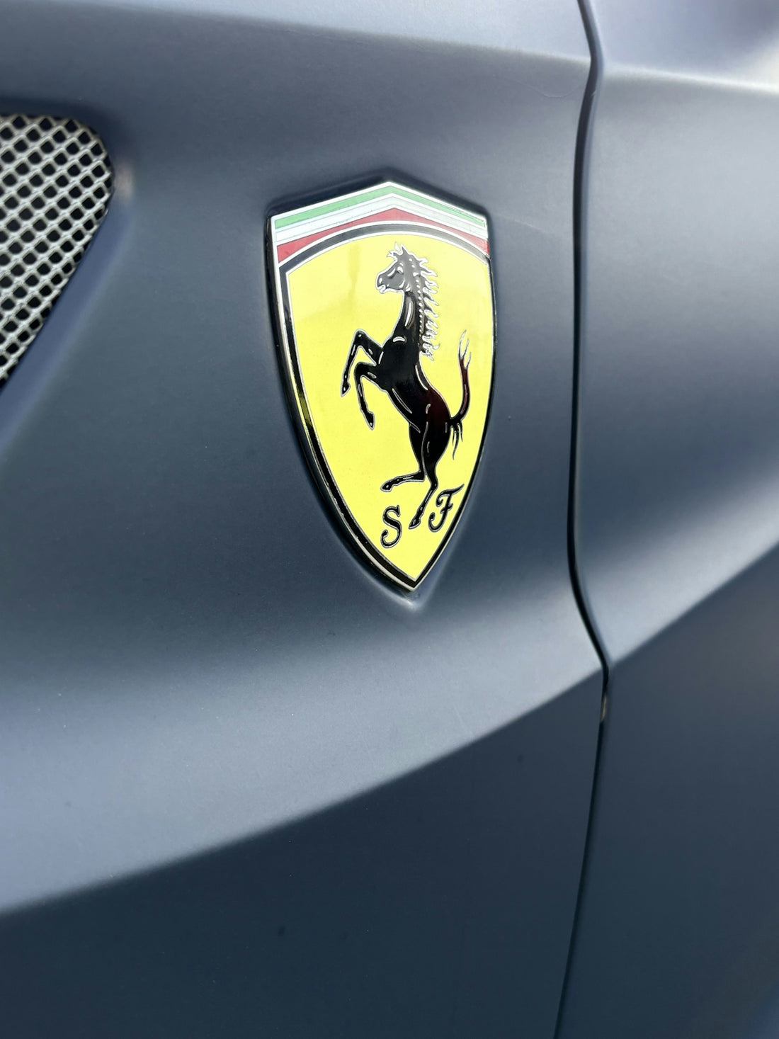 A ferrari emblem is shown on a car.