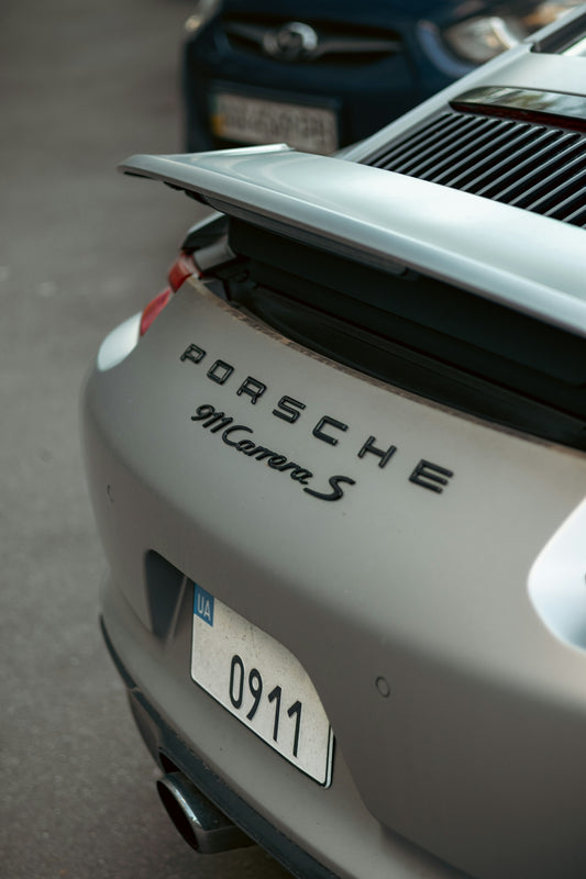 Porsche 911 carrera s rear details on display.