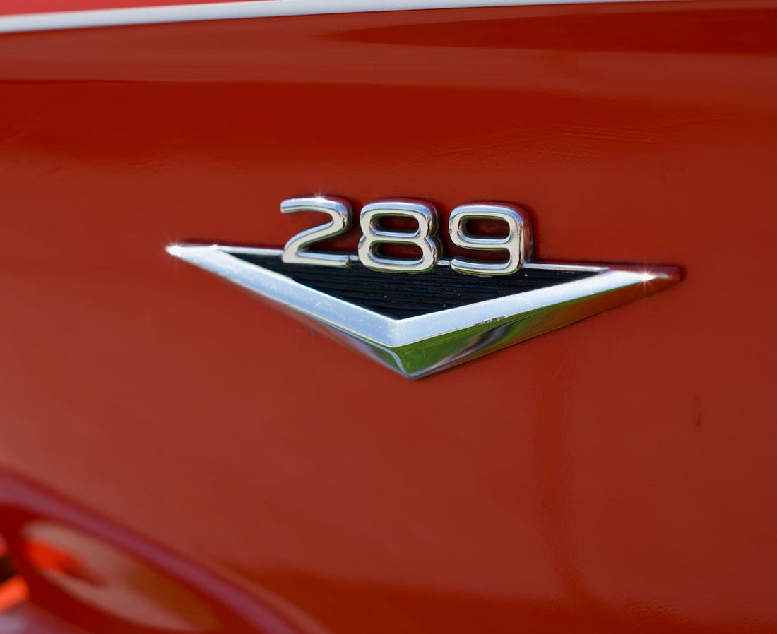 Chrome 289 emblem on red classic car fender, vintage muscle car detail
