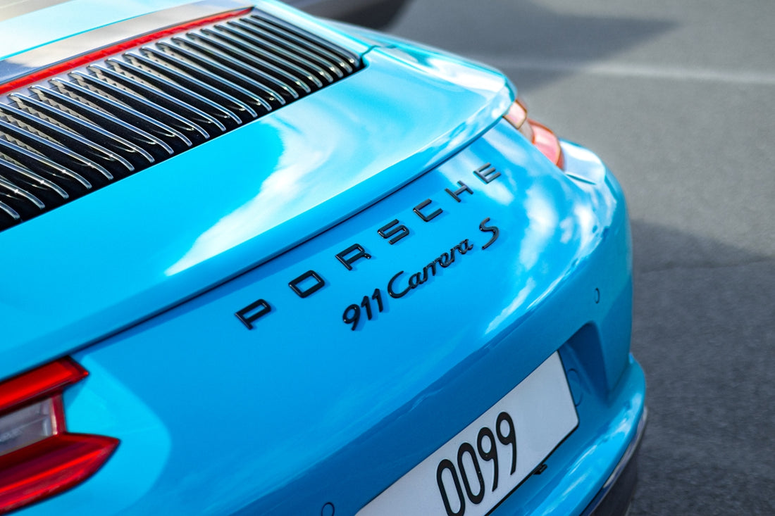 A turquoise porsche 911 carrera s.