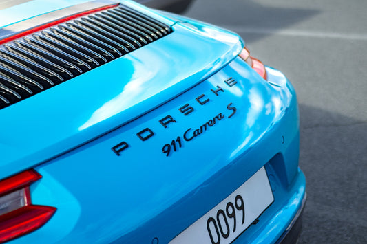 A turquoise porsche 911 carrera s.