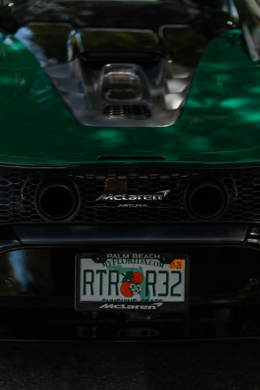 The rear end of a green mclaren artura.