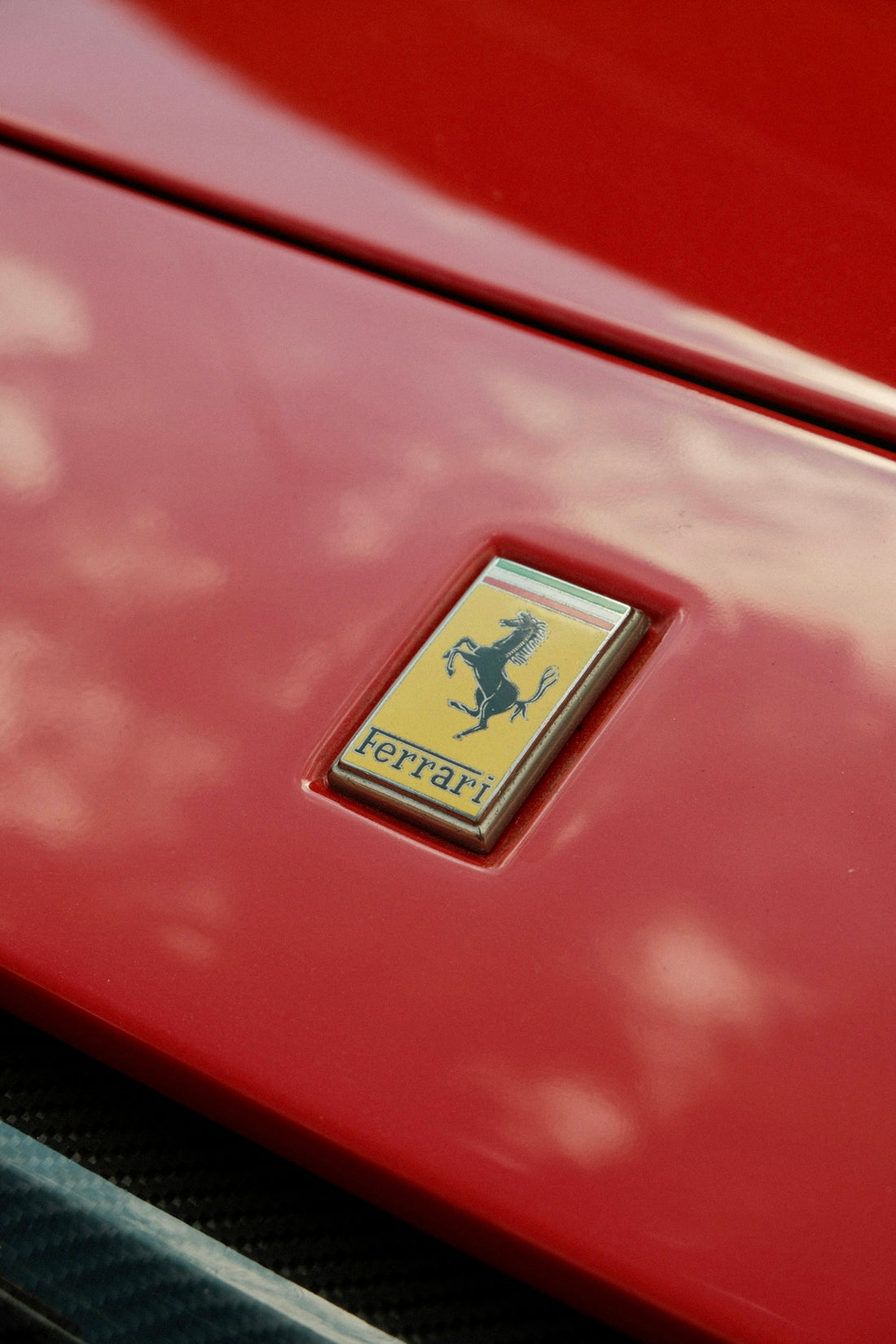 The ferrari logo is displayed on red paint.