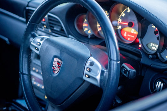 A porsche steering wheel with its gauges.