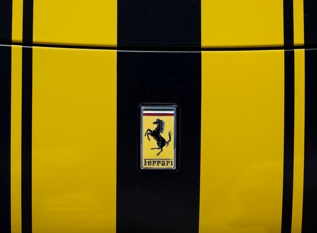 Ferrari logo on a yellow and black striped car.