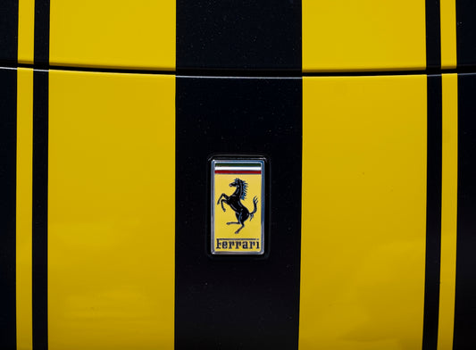 Ferrari logo on a yellow and black striped car.